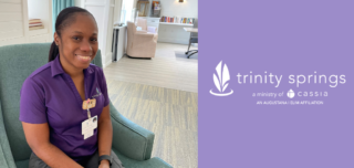 Certified Nursing Assistant LaSoy Smythe in a purple shirt smiling at the camera