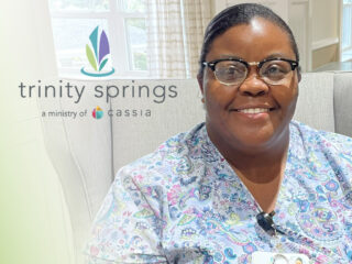 Chanteau Lynette Parris wearing a floral shirt smiling at the camera