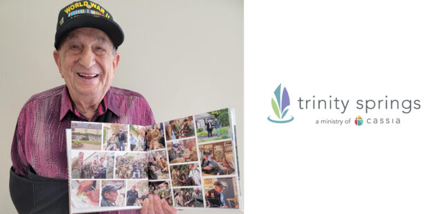 Trinity Springs resident and World War II veteran Irving Locker holds a photo book, proudly showcasing memories from his time in service.