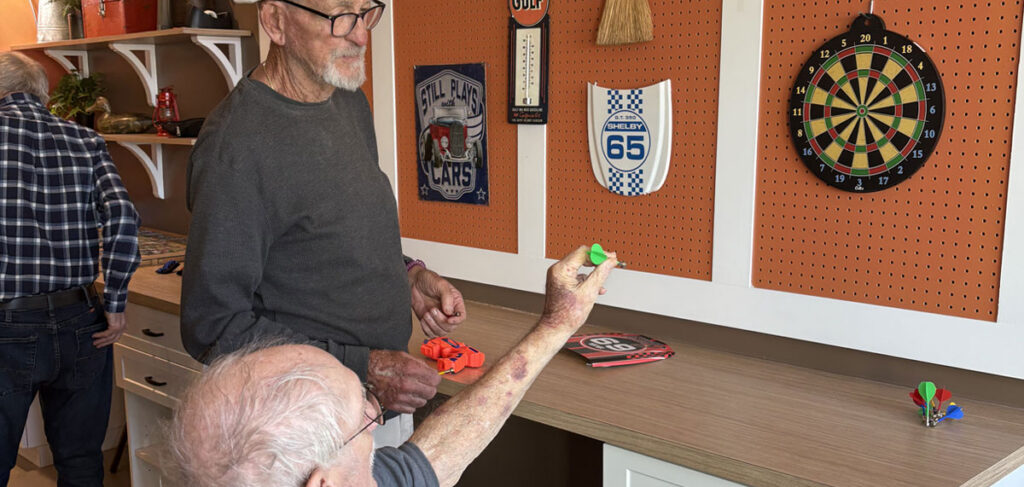 Resident playing magnetic darts
