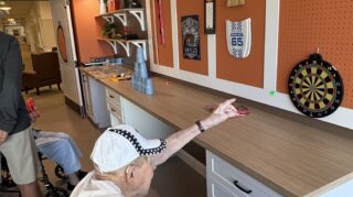 Resident playing magnetic darts