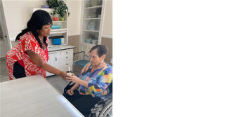 Staff member serves a snack to a memory care resident at Trinity Springs.
