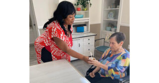 Staff member serves a snack to a memory care resident at Trinity Springs.