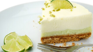 Slice of key lime pie with lime garnish on a plate, representing chef-prepared desserts and dining experiences like at Trinity Springs