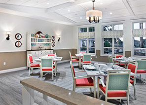 Dining room with tables, chairs, place settings, large windows, and comfortable seating in a bright restaurant-style setting at Trinity Springs