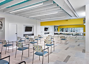 Fitness classroom with chairs arranged for group exercise, open activity space, television, and adjacent wellness area at Trinity Springs