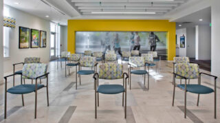 Fitness studio with chairs arranged for exercise classes, open workout space, large windows, and wellness-themed décor at Trinity Springs
