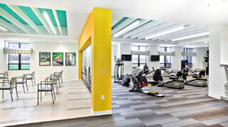 Fitness and wellness center with cardio equipment, strength-training machines, group exercise space, large windows, and televisions at Trinity Springs