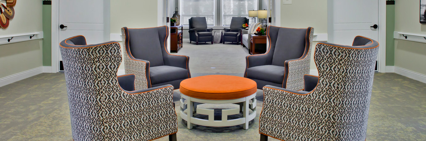 Lounge seating area with upholstered armchairs arranged around a round table in a comfortable gathering space at Trinity Springs