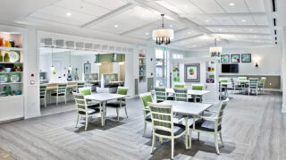 Main dining room with tables, chairs, built-in shelving, decorative lighting, booth seating, and open gathering spaces at Trinity Springs