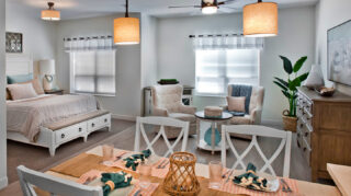 Studio apartment with bedroom, dining area, comfortable seating, large windows, and open-concept living space at Trinity Springs