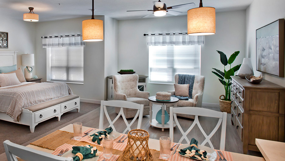 Studio apartment with bedroom, dining area, comfortable seating, and open living space, featuring a full kitchen layout at Trinity Springs